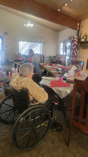 A cozy gathering at a care facility, with residents engaged in various activities.
