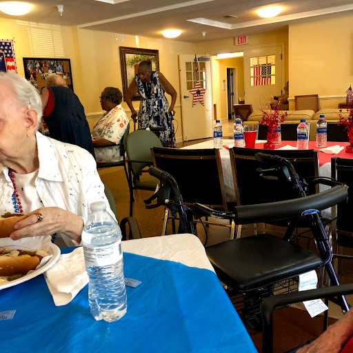 Seniors enjoying a meal together in a community dining area.