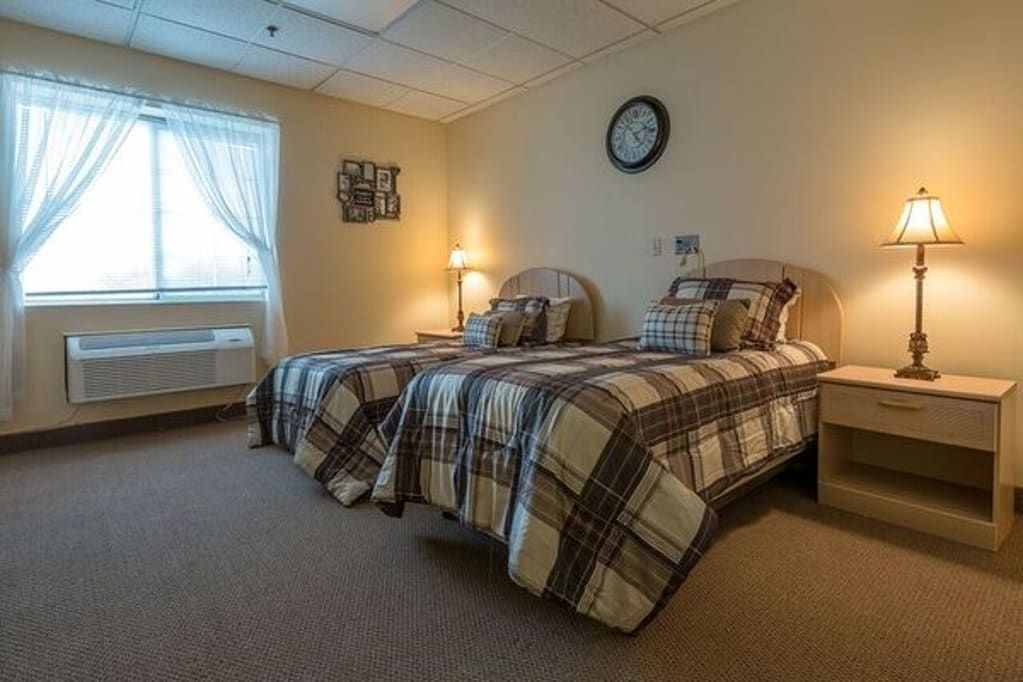 A cozy bedroom with twin beds and a warm ambiance.