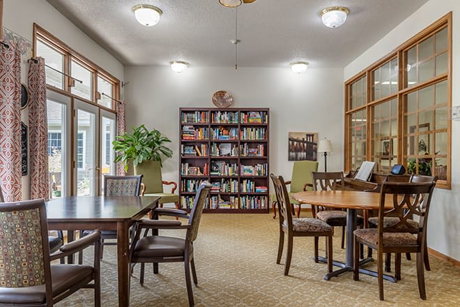 A cozy reading area with bookshelves and tables.