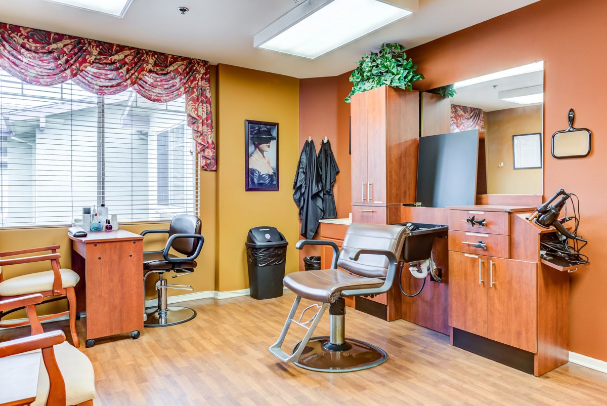 A well-organized hair salon interior featuring barber chairs, mirrors, and styling stations.