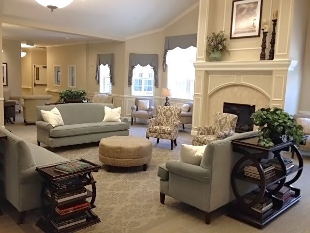 A cozy living room with sofas and a fireplace.