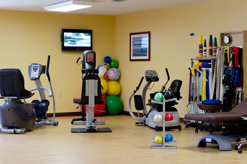 A well-equipped gym with various exercise machines and fitness equipment.