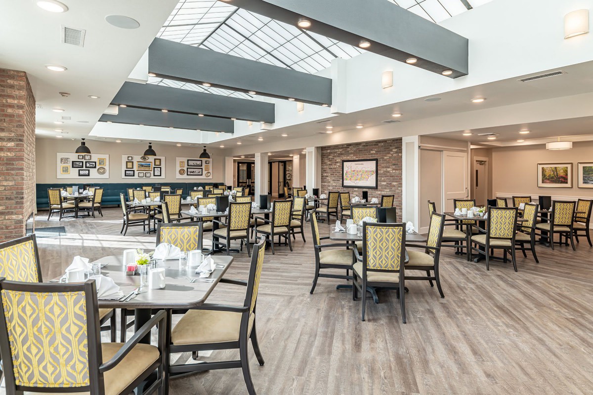 A modern restaurant dining area with ample seating and natural lighting.