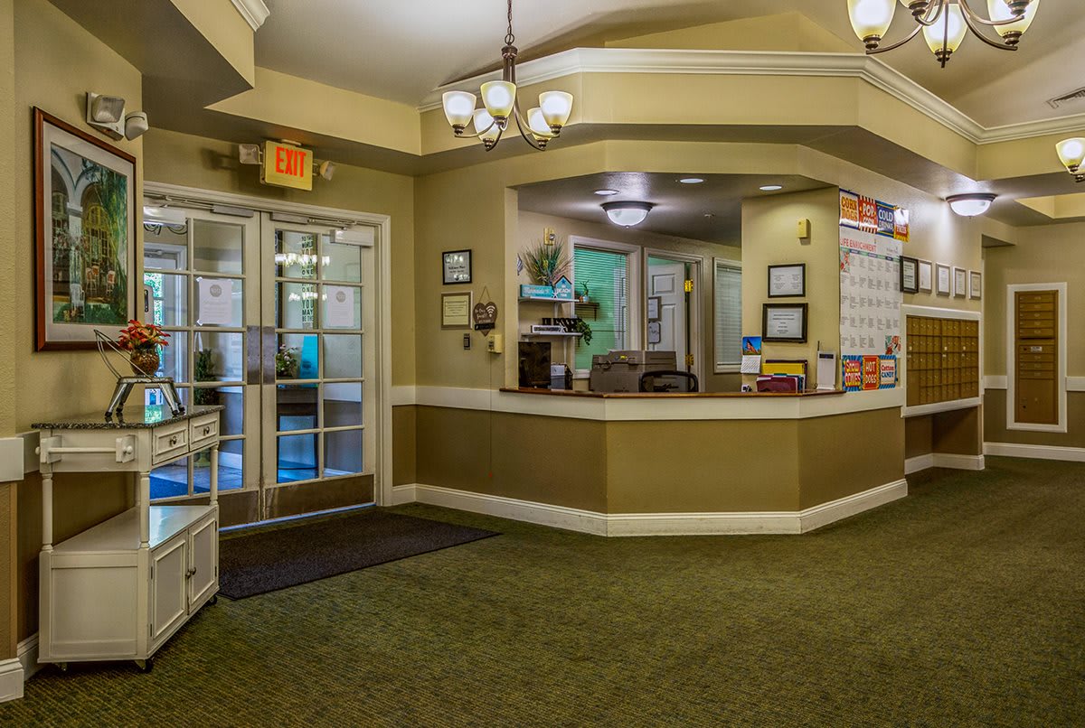 A spacious reception area with a central desk and bright lighting.