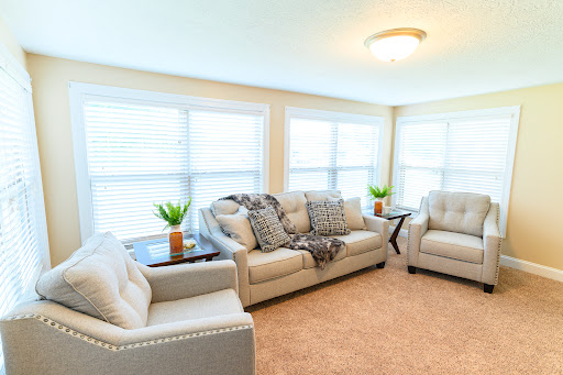 A bright and cozy living room featuring comfortable furniture and natural light.