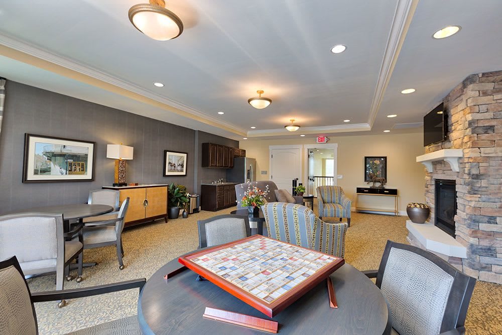 A modern living room with comfortable seating and a game board table.