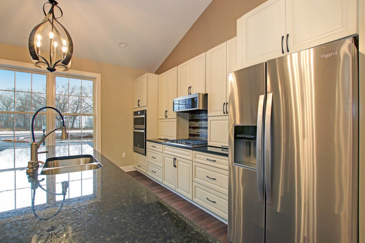 A modern kitchen with stainless steel appliances and ample natural light.