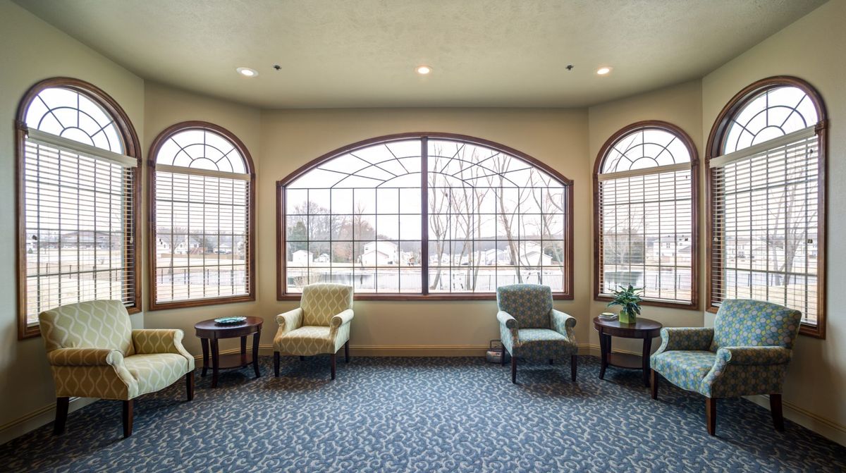 A cozy waiting area with comfortable chairs and large windows providing abundant natural light.
