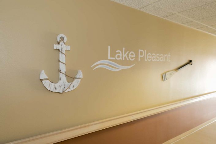 A nautical-themed wall in a hallway displaying an anchor and the text 'Lake Pleasant'.