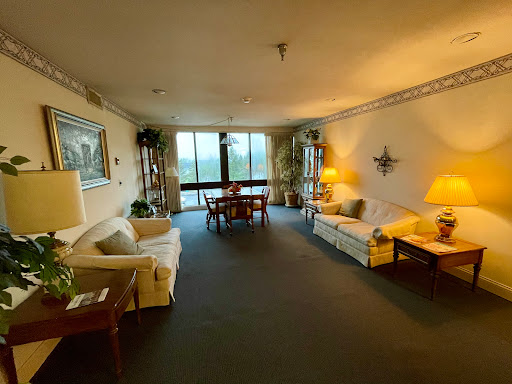 A spacious living room featuring comfortable seating, a dining area, and ample natural light.