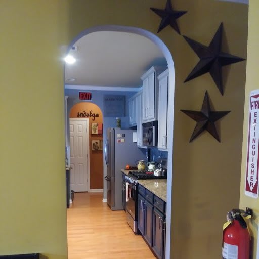 A cozy kitchen view through an archway, adorned with star decorations.