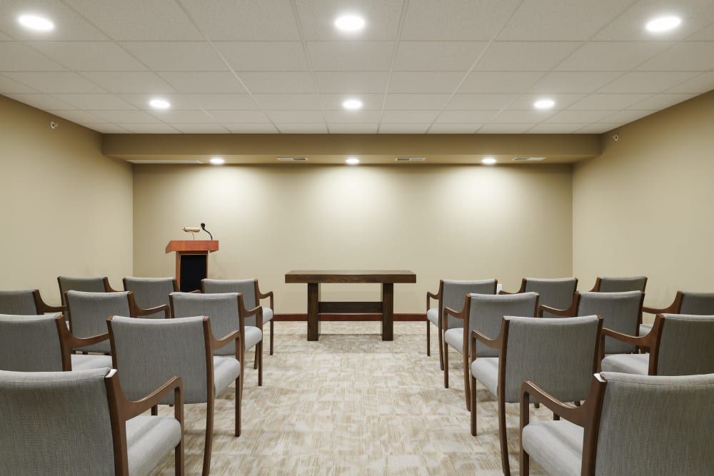 A small conference room setup with chairs facing a podium.