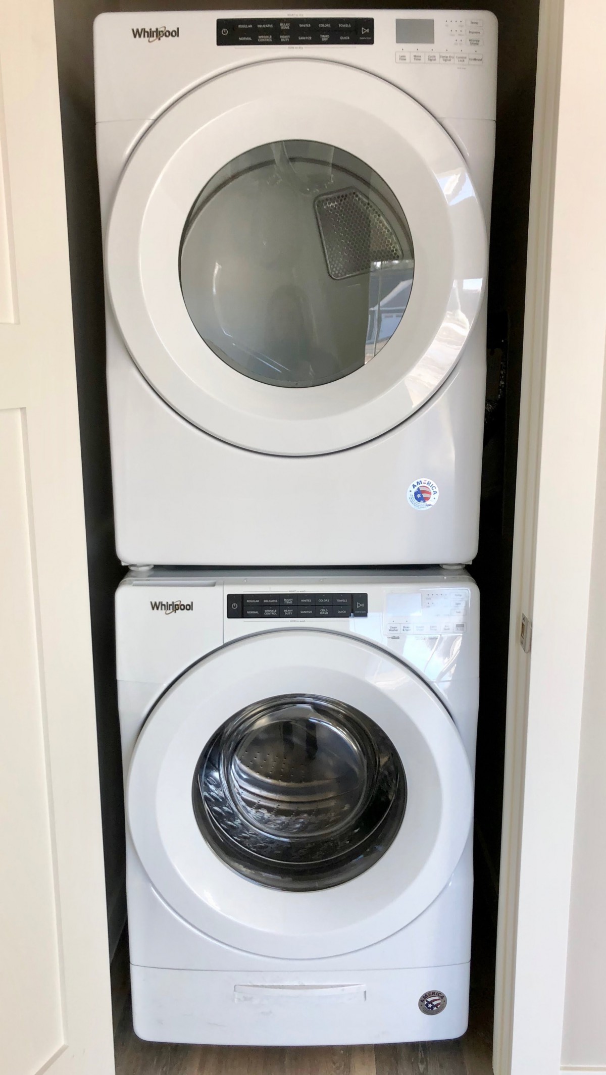 Stacked washer and dryer in a closet.