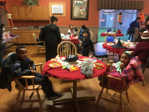 A festive gathering with children enjoying a meal around a decorated table.