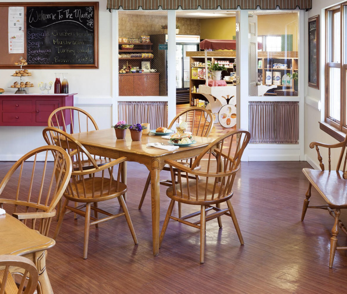 Cozy restaurant dining area with wooden chairs and tables.
