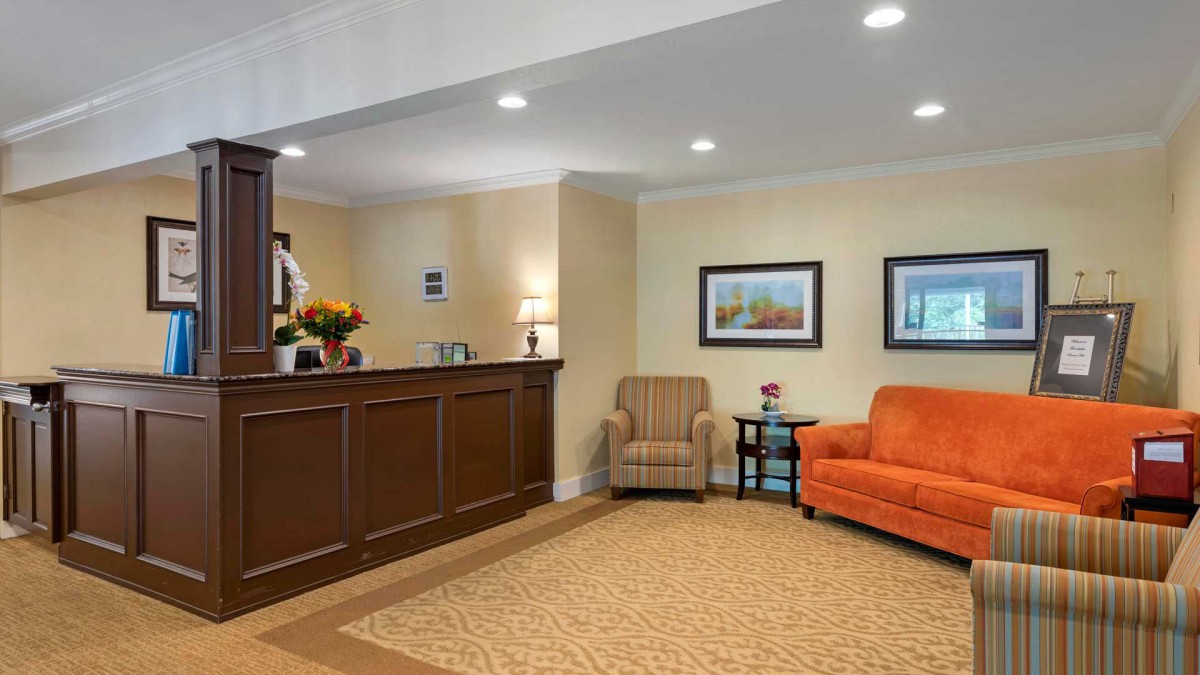 A cozy lobby area with comfortable seating and a reception desk.