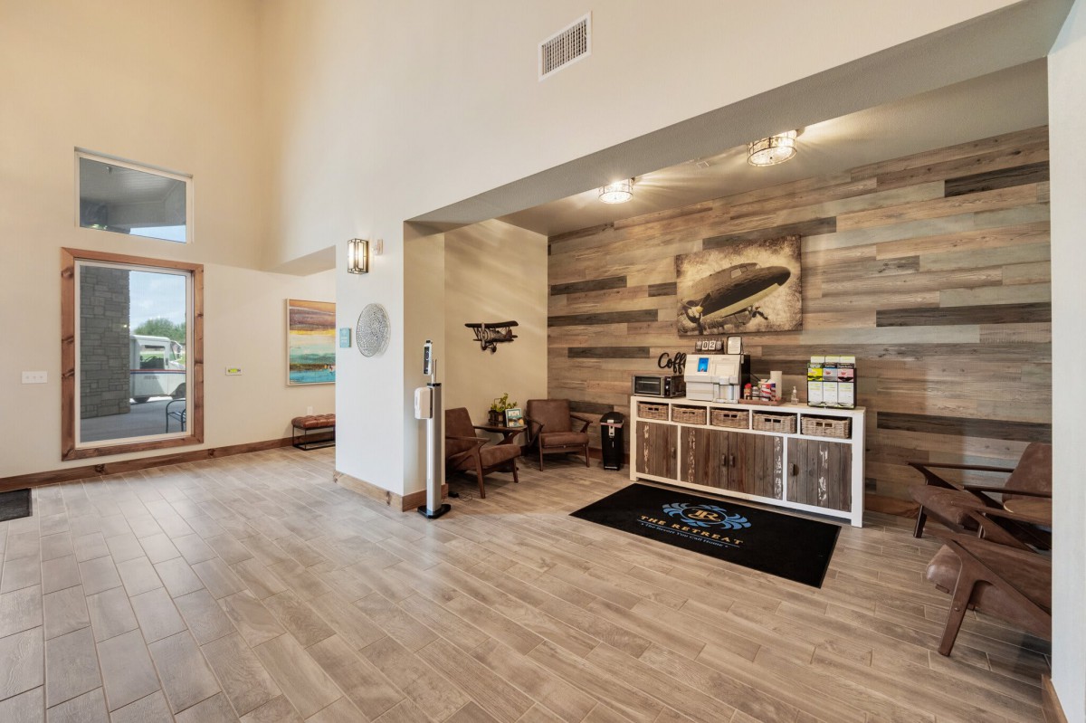 A modern lobby with a cozy waiting area featuring wooden accents and stylish furniture.