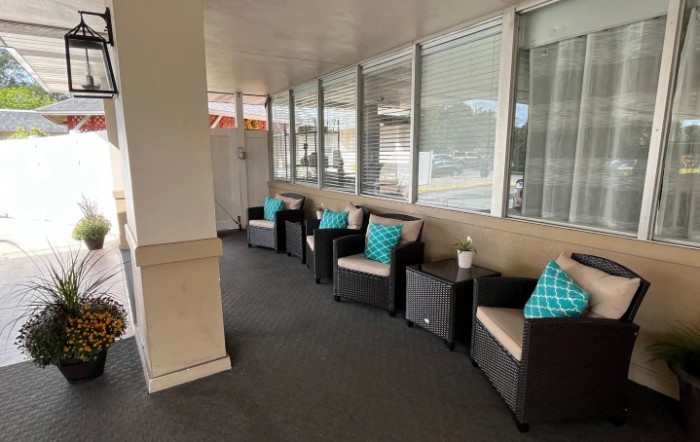 Comfortable outdoor seating area with cushioned chairs and turquoise pillows.