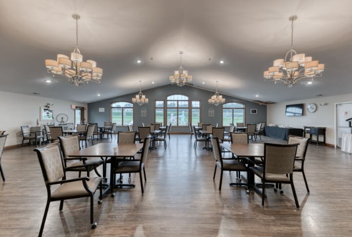 A spacious dining hall with elegant chandeliers and modern decor.