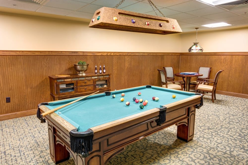 A cozy game room featuring a pool table and seating area.