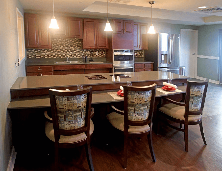 Modern kitchen with a large island, pendant lighting, and stylish barstools.