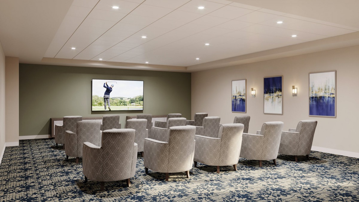 A modern meeting room with theater-style seating and a large screen for presentations.