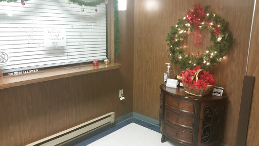 A cozy corner decorated for the holiday season with a festive wreath and seasonal decor.