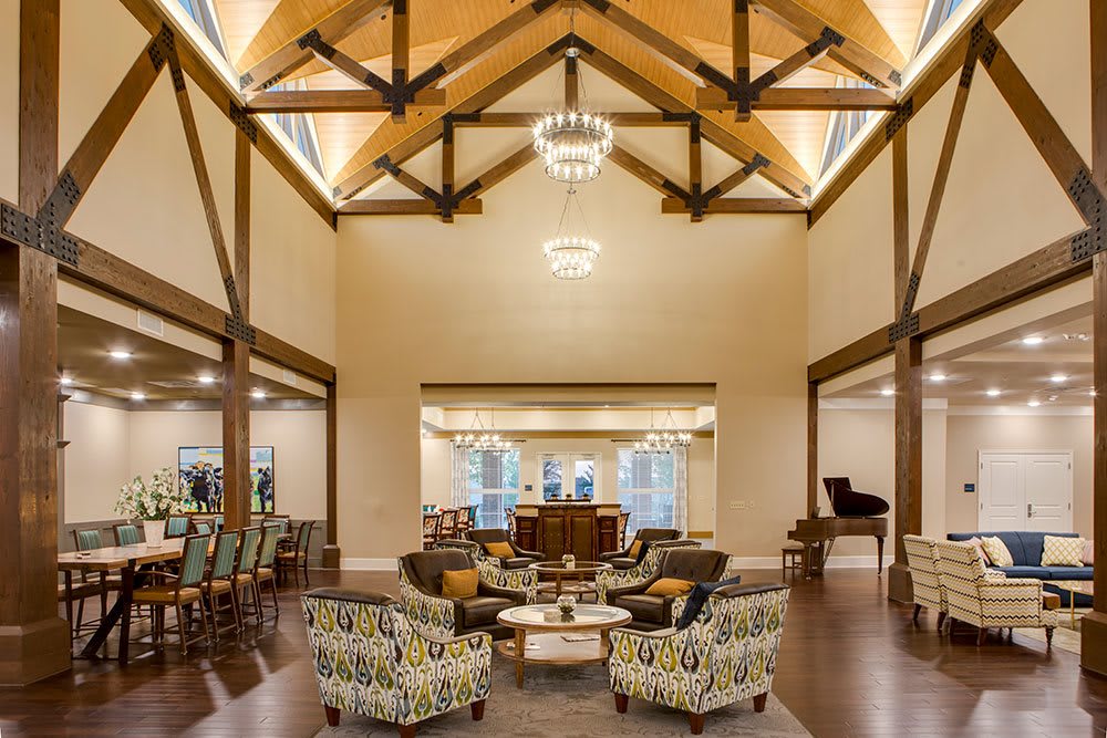 A spacious and elegant lounge with high ceilings and comfortable seating arrangements.