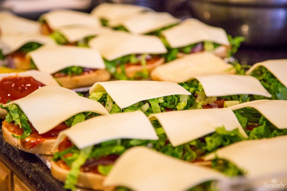 Delicious sandwiches topped with fresh lettuce and cheese slices.