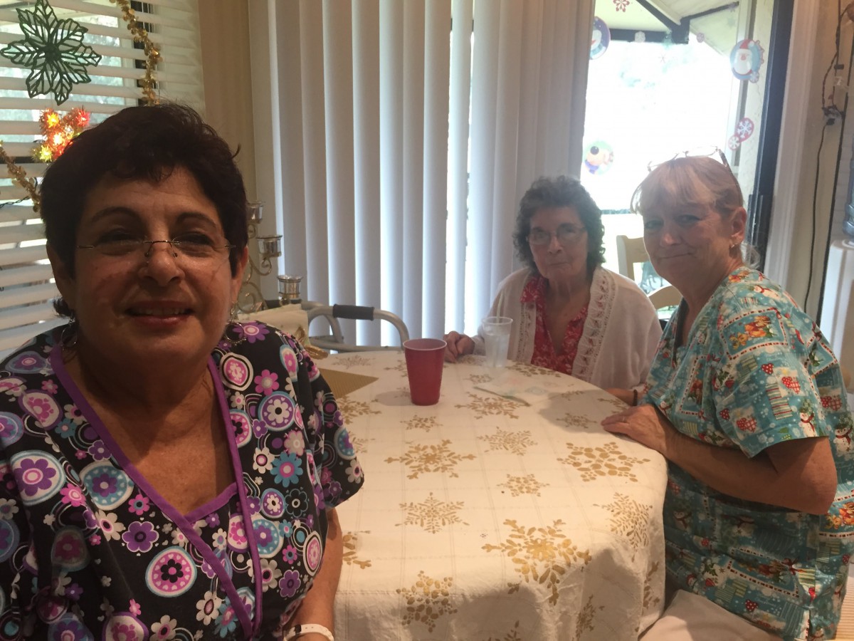 A group of people sitting around a table indoors.
