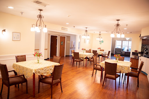 A cozy dining area with neatly arranged tables and warm lighting.