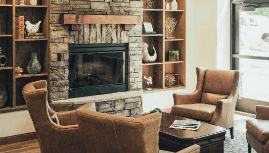 Cozy living room with a stone fireplace and comfortable seating.