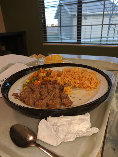 A plate of savory beef with rice and mixed vegetables, ready for a delicious meal.