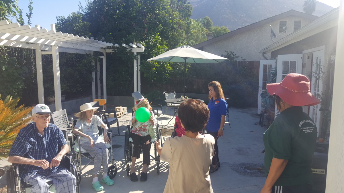 A group of seniors enjoying a sunny day on the patio.