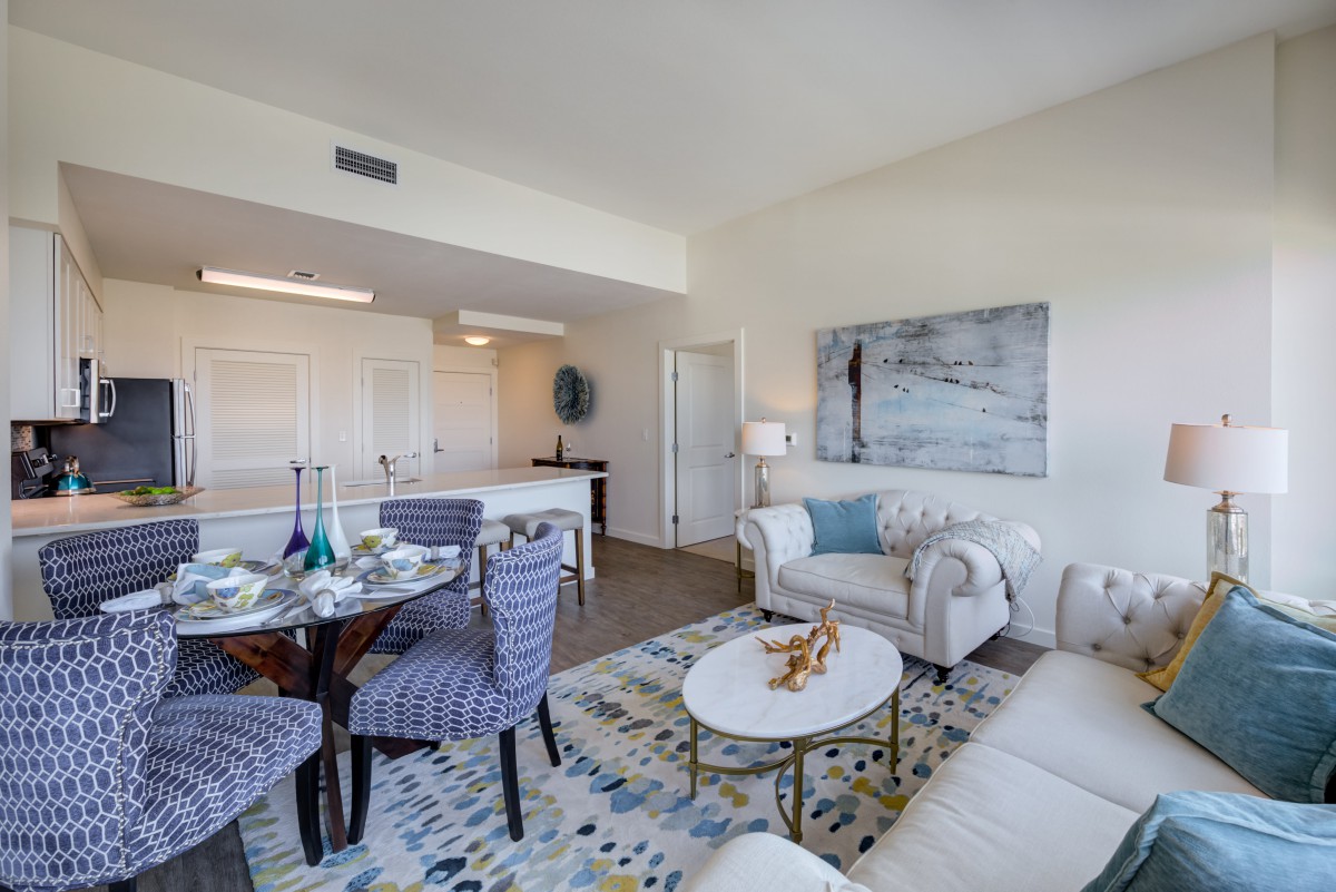 A modern living and dining area with stylish furniture and bright lighting.