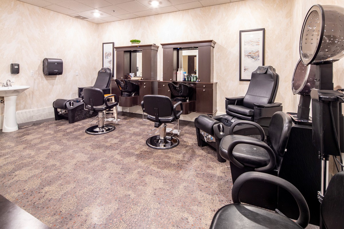 A well-organized salon with styling chairs and mirrors.