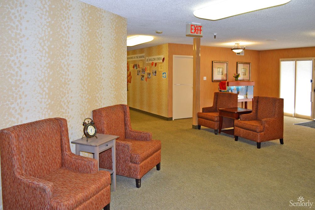A cozy waiting area with comfortable chairs and a hallway leading further inside.