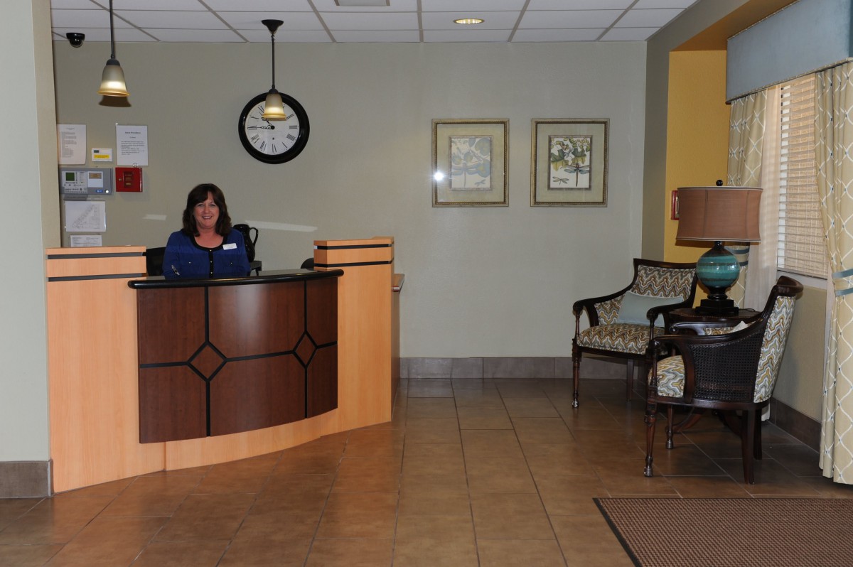 An office lobby with a reception desk and a seating area.