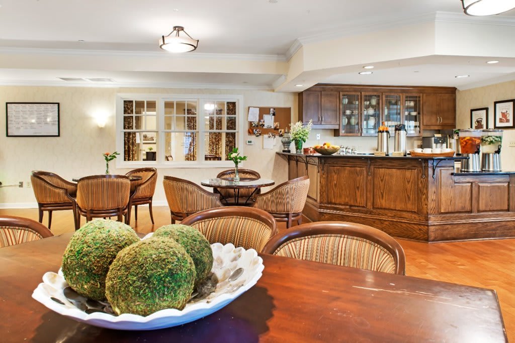 A cozy kitchen and dining area featuring wooden furniture and soft lighting.