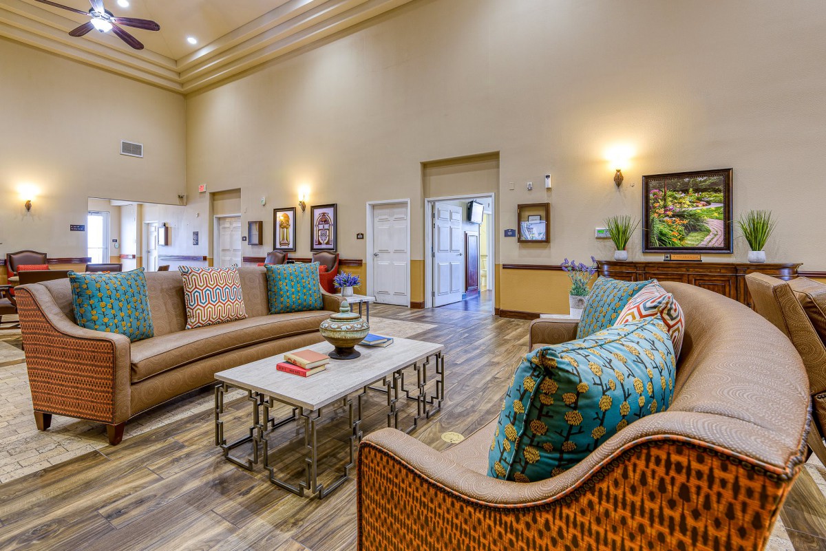 A spacious living room with stylish furniture and warm lighting.