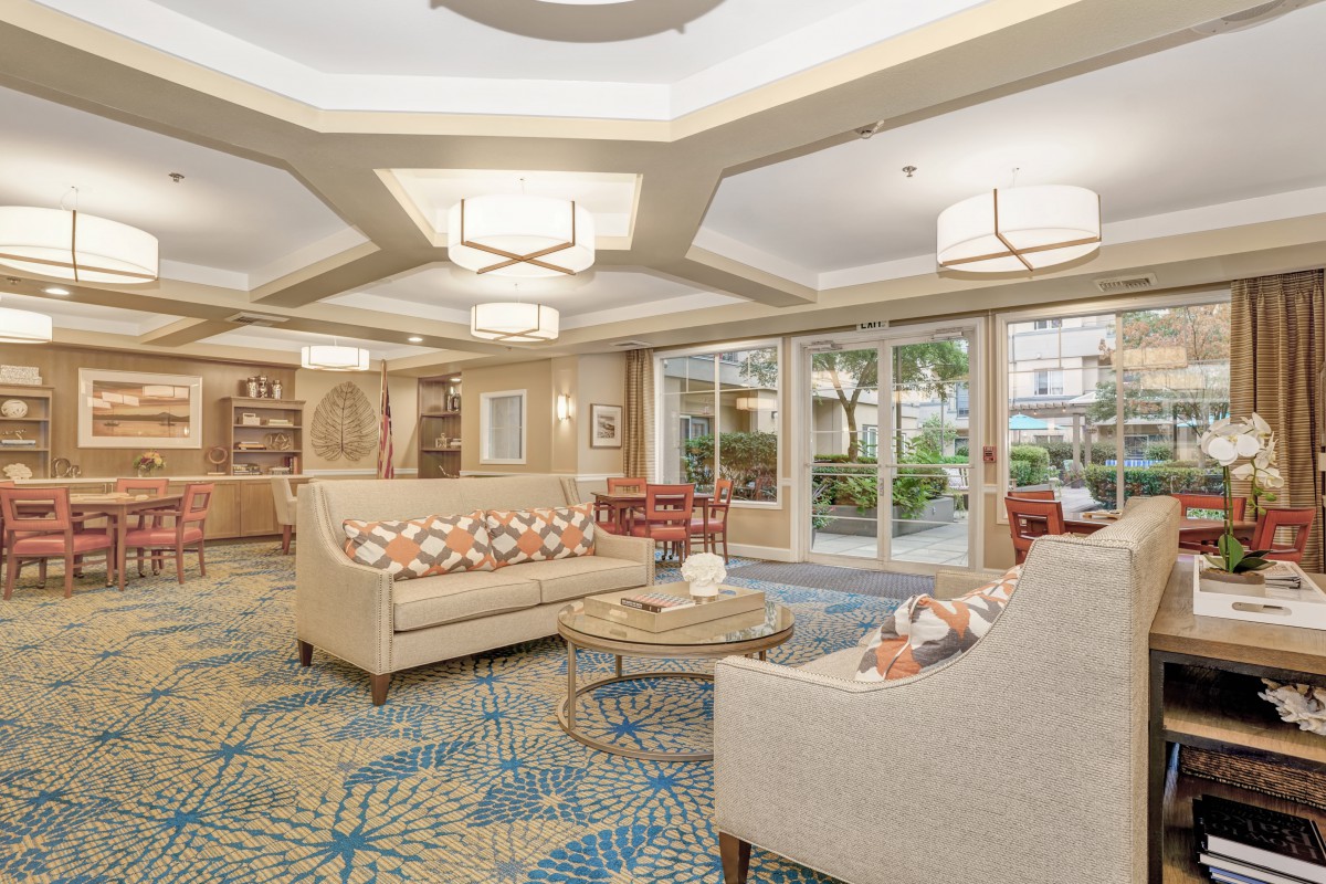 A spacious hotel lobby featuring modern decor with comfortable seating and elegant lighting.