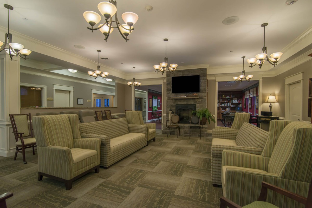 A stylish lounge area featuring comfortable sofas and elegant chandeliers.