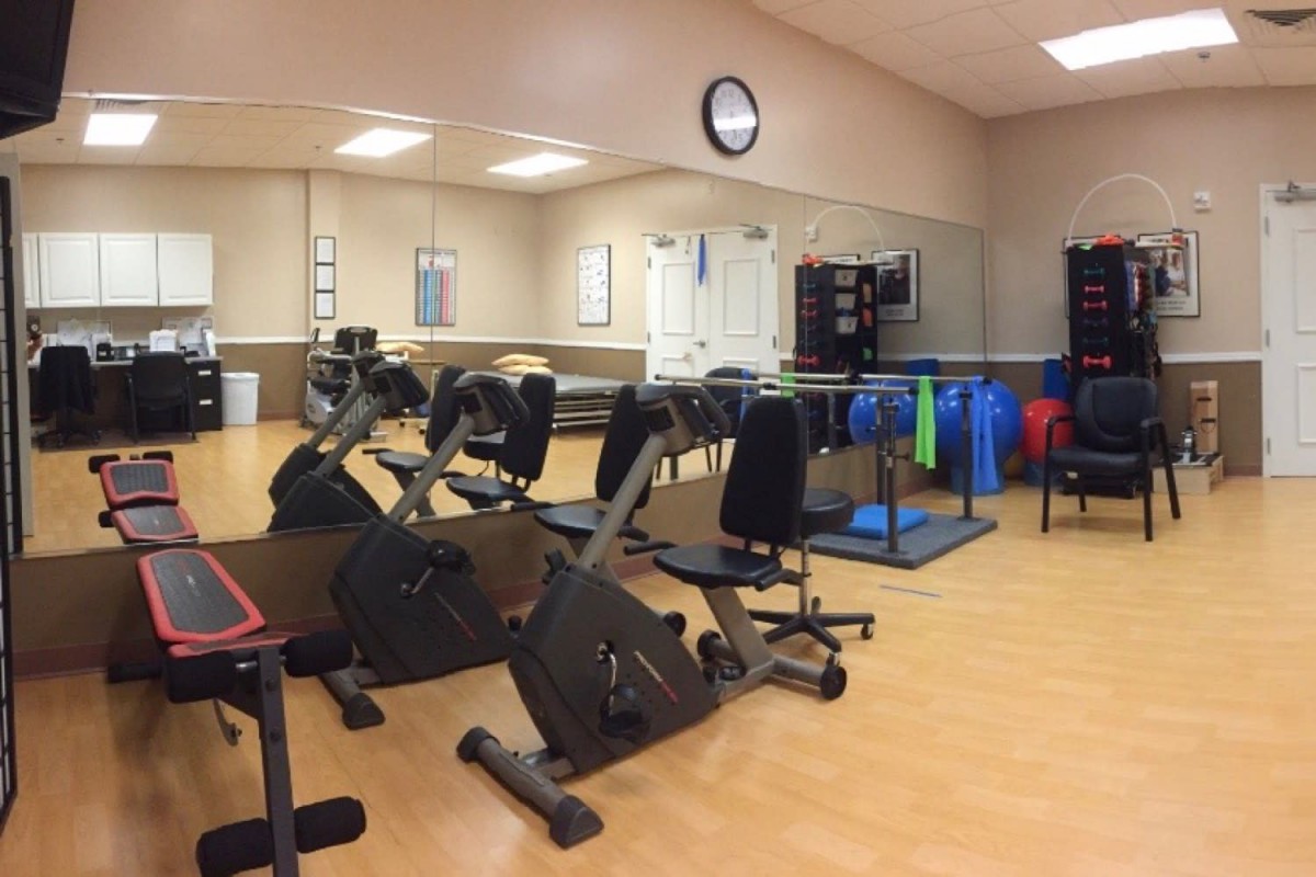 A spacious gym room with exercise bikes and fitness equipment.
