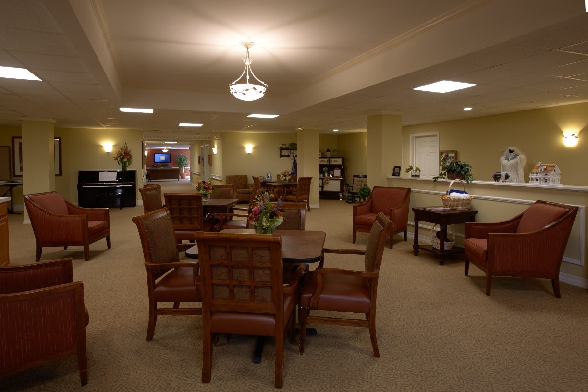 A spacious and well-lit dining area with multiple tables and chairs.
