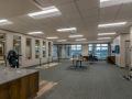 A spacious and modern office interior with desks and ample lighting.