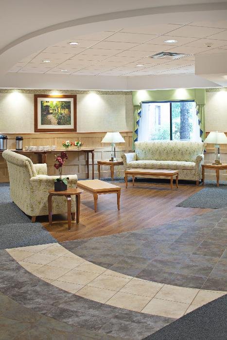 A cozy lobby area featuring sofas and a coffee table, with soft lighting enhancing the welcoming atmosphere.