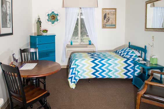 Cozy bedroom with blue-themed decor and furniture.