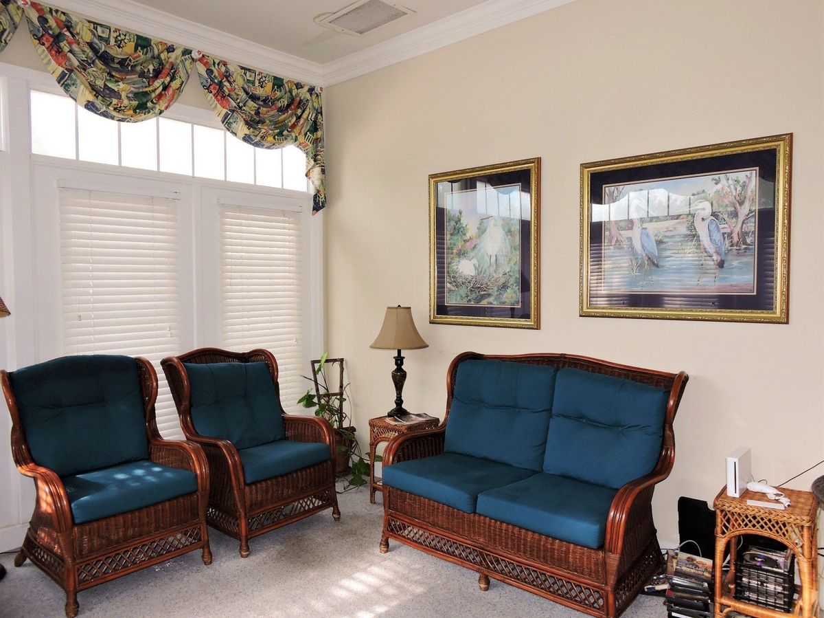 A cozy living room with upholstered furniture and decorative elements.