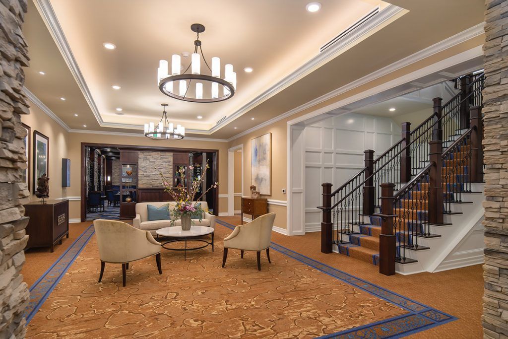 Elegant lobby with comfortable seating and a grand staircase.